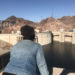 Ashley a.k.a girlwithherviews at the hoover dam overlooking the water from a tourist viewpoint