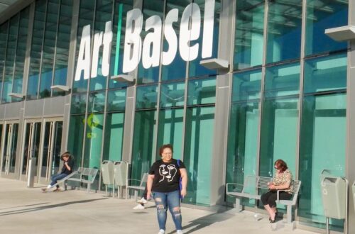 Ashley standing in front of the entrance to Art Basel Miami Beach 2019