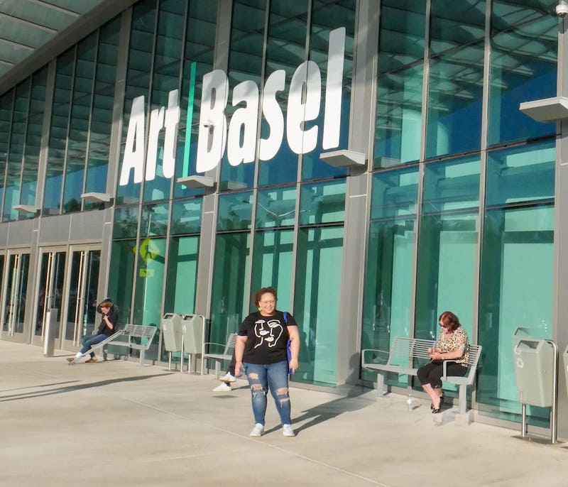 Ashley standing in front of the entrance to Art Basel Miami Beach 2019